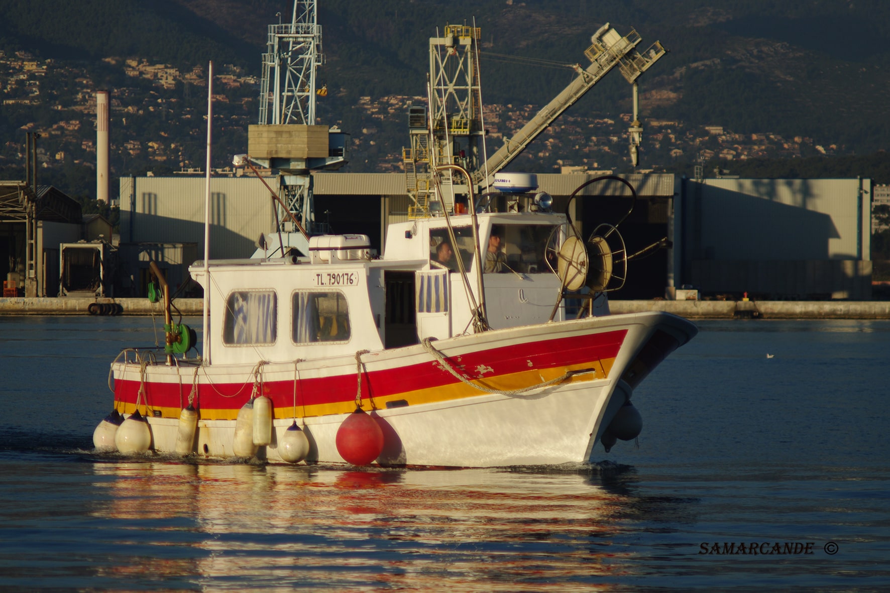 Bateau rouge et blanc sortant du port